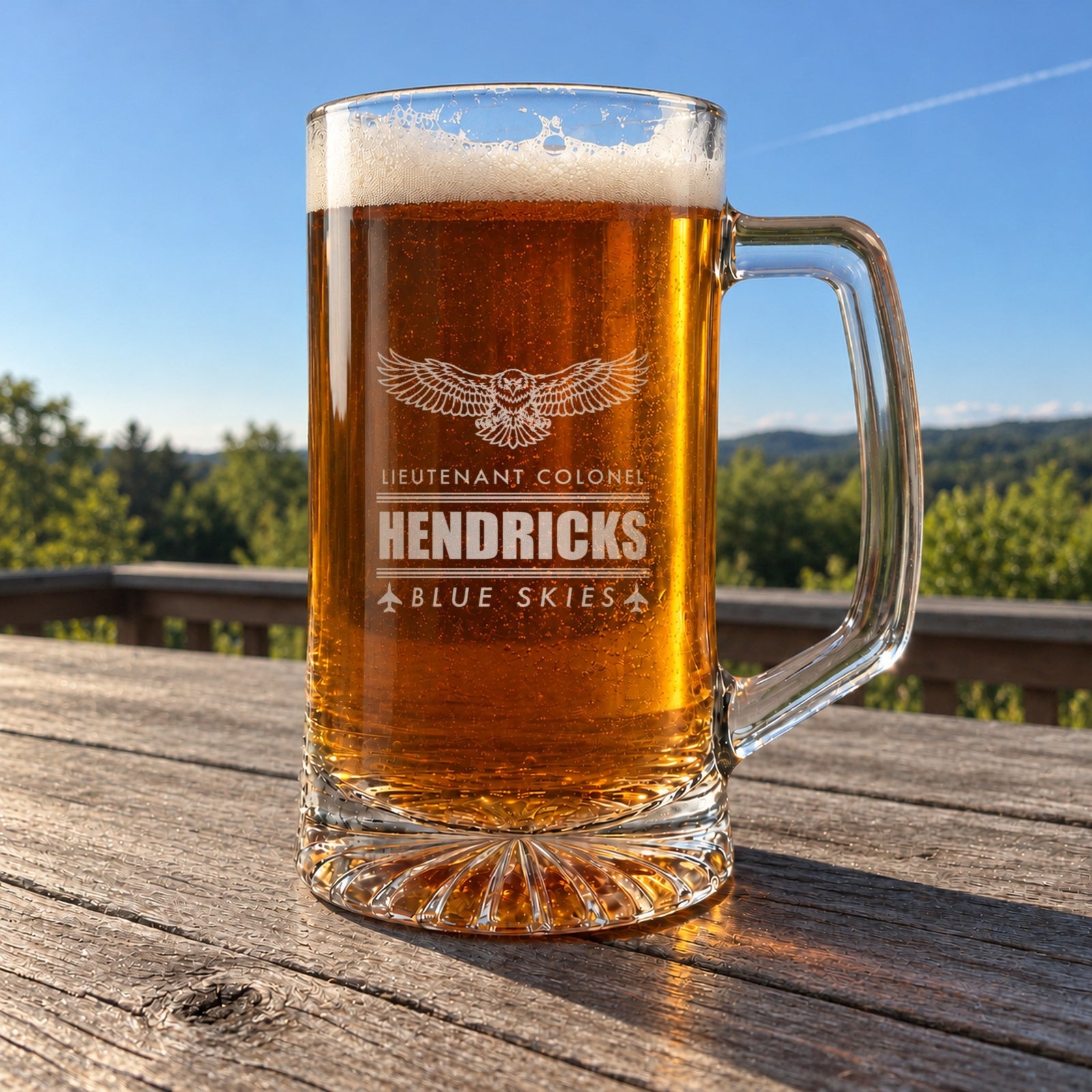 Air Force retirement beer stein on a deck table under a clear blue sky, engraved with an eagle, Lieutenant Colonel, Hendricks and Blue Skies