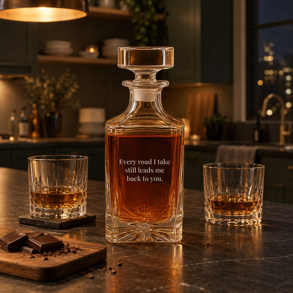 Anniversary gift for boyfriend: a whiskey decanter engraved on the back with Every road I take still leads me back to you, on a kitchen island at night