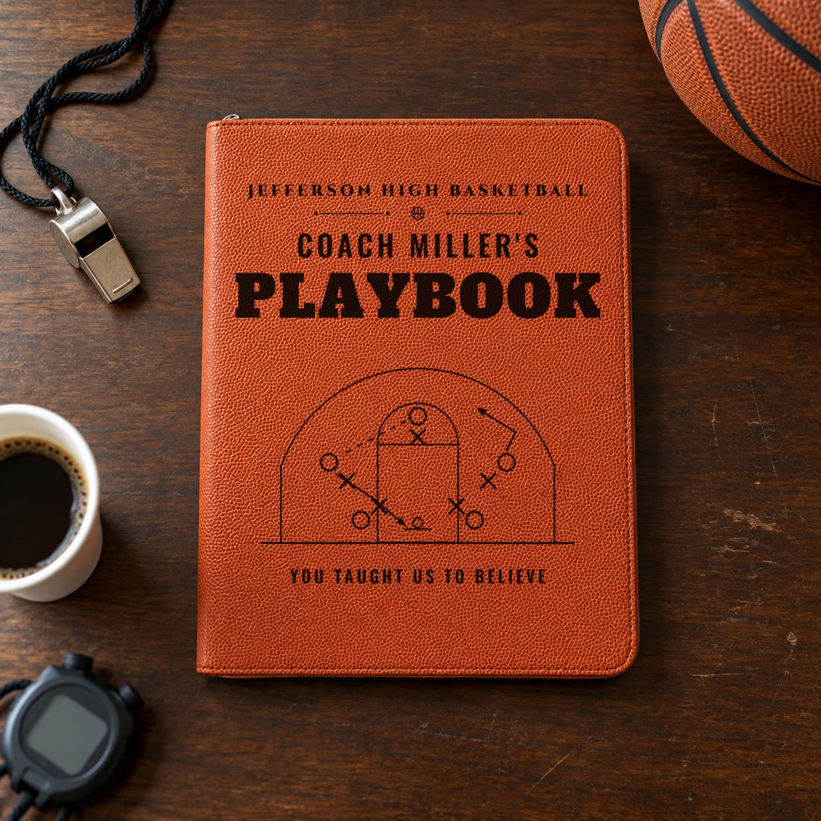 Basketball coach gift portfolio engraved Jefferson High Basketball, Coach Miller's Playbook and You taught us to believe on a coach's desk with a whistle