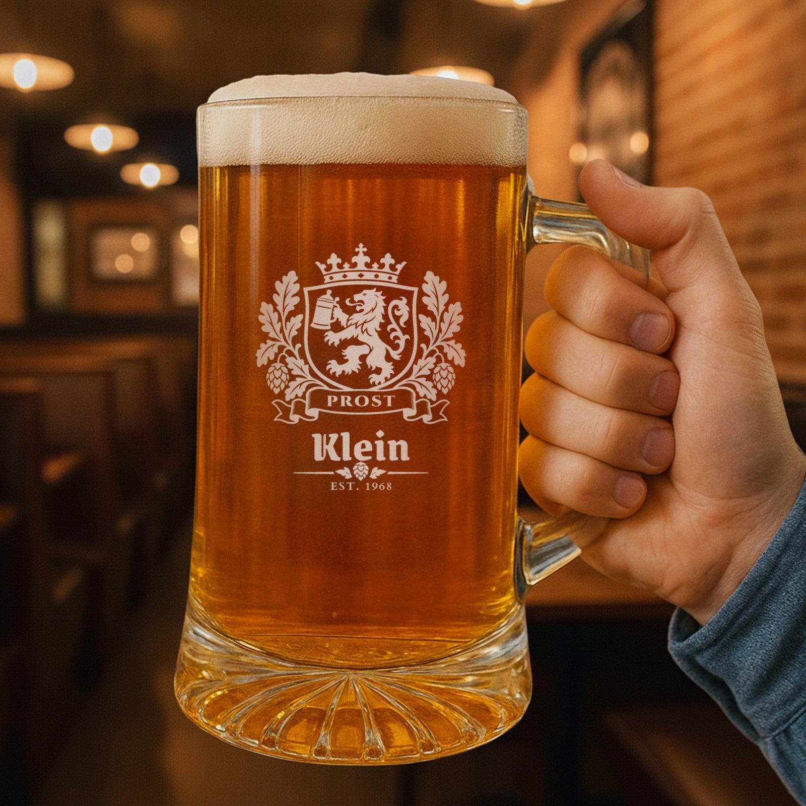 Hand holding a 25 oz Bavarian crest personalized beer stein in a pub, engraved with the lion crest, Prost, Klein and Est. 1968