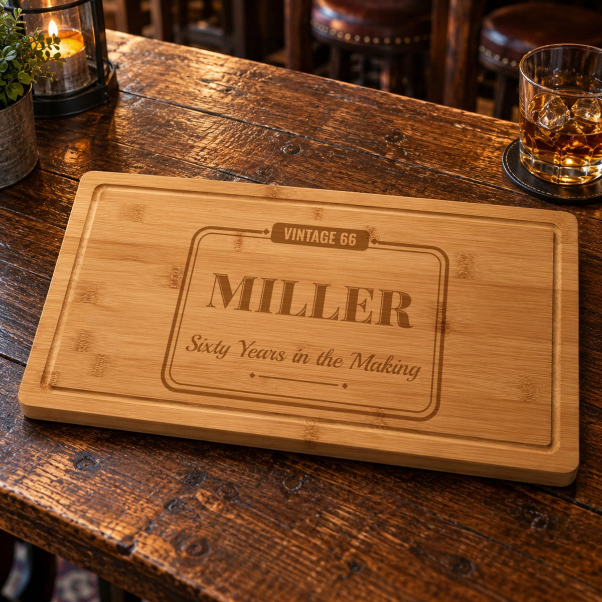Bamboo birthday cutting board on a tavern table engraved Vintage 66, Miller and Sixty Years in the Making, a personalized 60th birthday gift