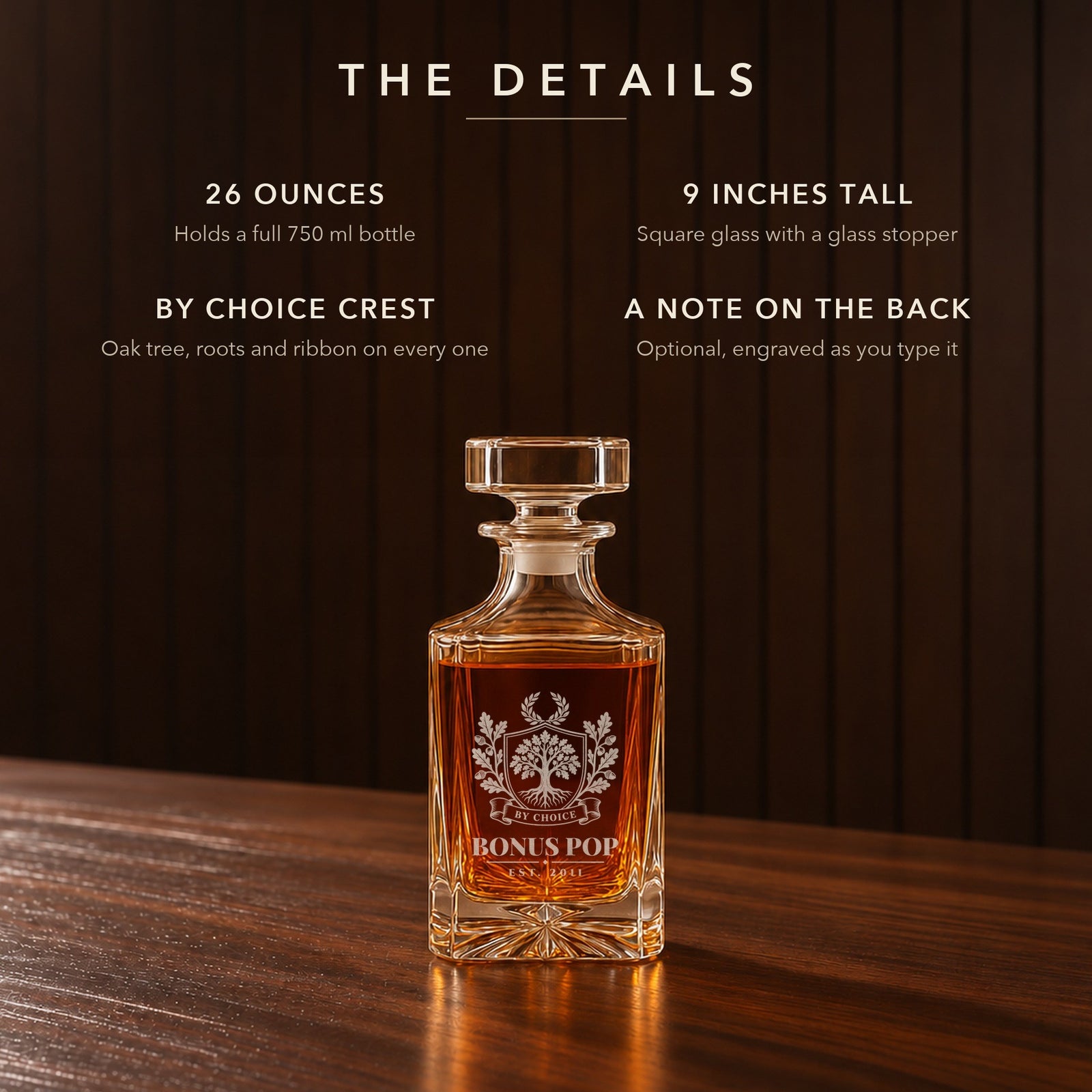 Details of the bonus dad whiskey decanter: 26 oz, 9 inches tall, the By Choice crest engraved Bonus Pop, Est. 2011, and a note on the back