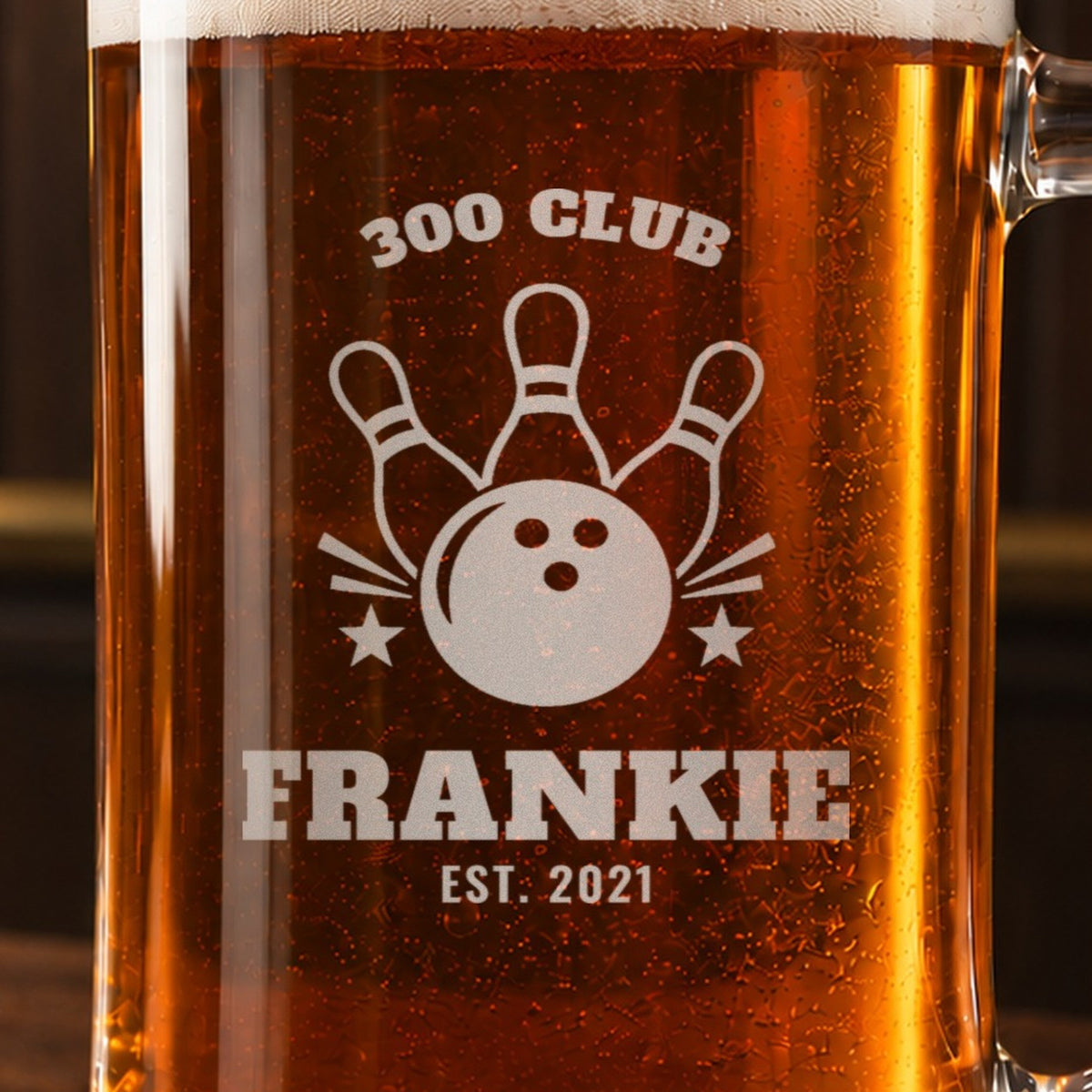 Close-up of the frosted engraving on the bowling beer mug, a bowling ball and three pins: 300 Club, Frankie, Est. 2021