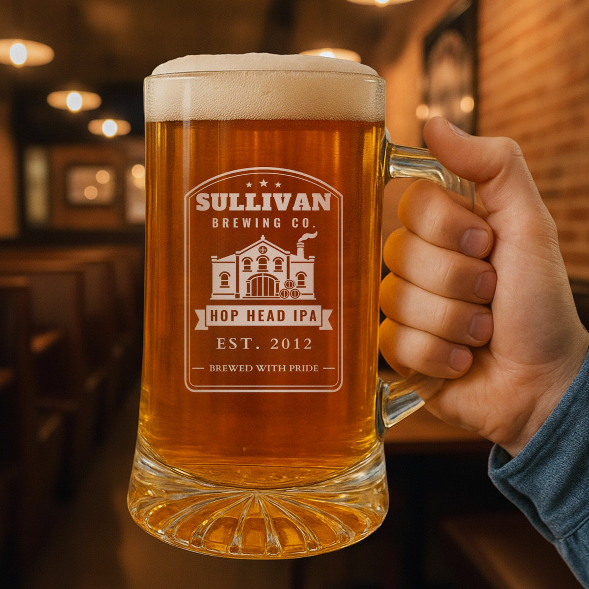 Hand holding the personalized Brewing Co. beer stein in a pub, engraved SULLIVAN BREWING CO. with HOP HEAD IPA on the banner and EST. 2012