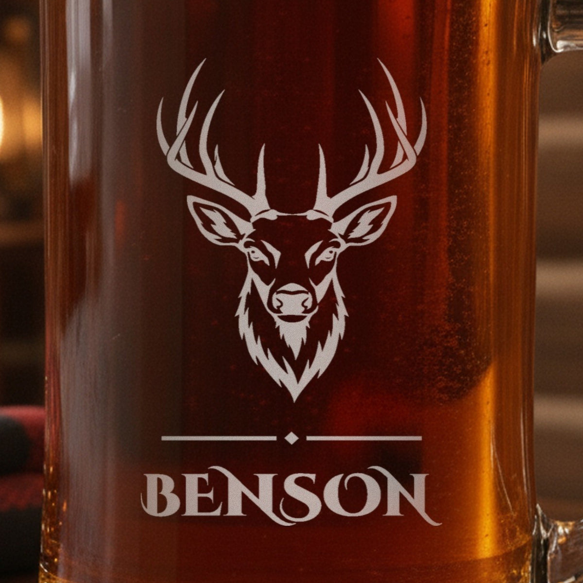 Close-up of the frosted laser engraving on the hunting beer stein: a detailed whitetail buck, a fine rule and the name Benson beneath it