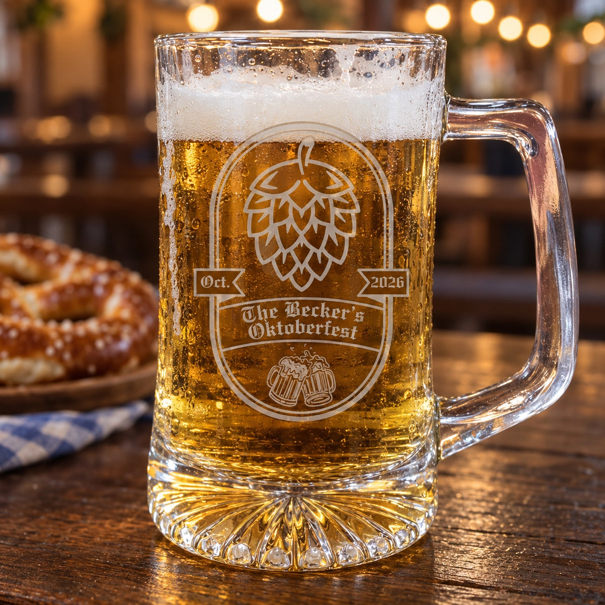 Custom Oktoberfest mug full of lager on a beer hall table, engraved with a hop badge, Oct. and 2026 ribbons and The Becker's Oktoberfest