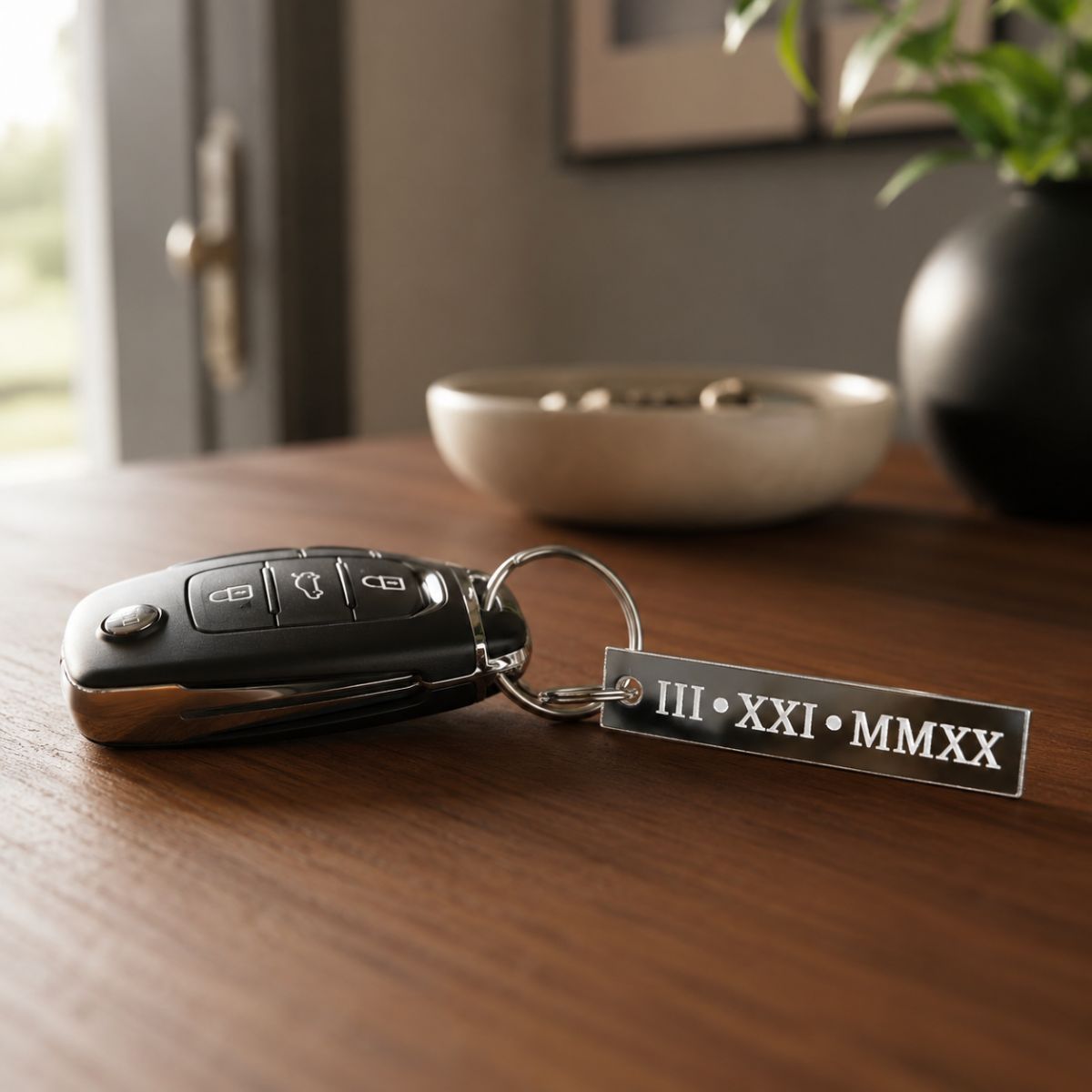 Key fob with a metal tag displaying 'III XXI MMXX' on a wooden surface.