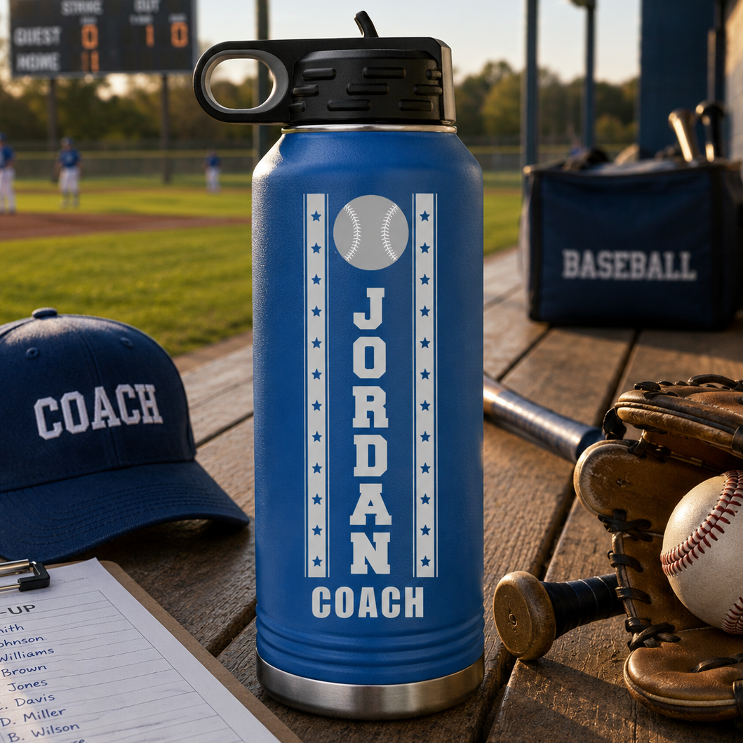 Blue insulated water bottle with sample engraving reading "JORDAN COACH" and baseball design, displayed on baseball field dugout with coach hat and equipment.