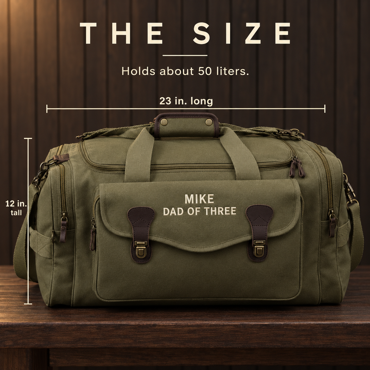 Size card showing the olive green dad duffle bag is 23 inches long and 12 inches tall and holds about 50 liters, embroidered MIKE and DAD OF THREE