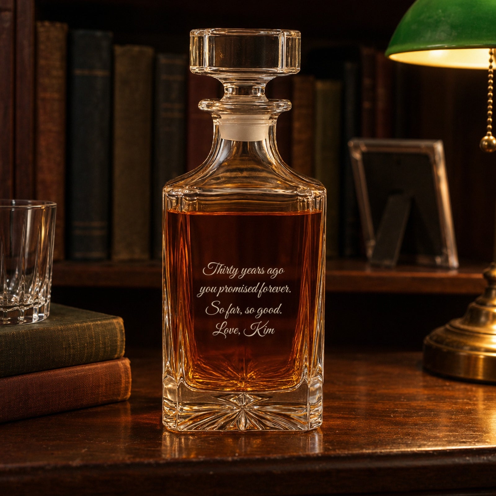 Back of a 30 year anniversary gift for him, engraved Thirty years ago you promised forever, so far, so good, on a study bookshelf by a green lamp
