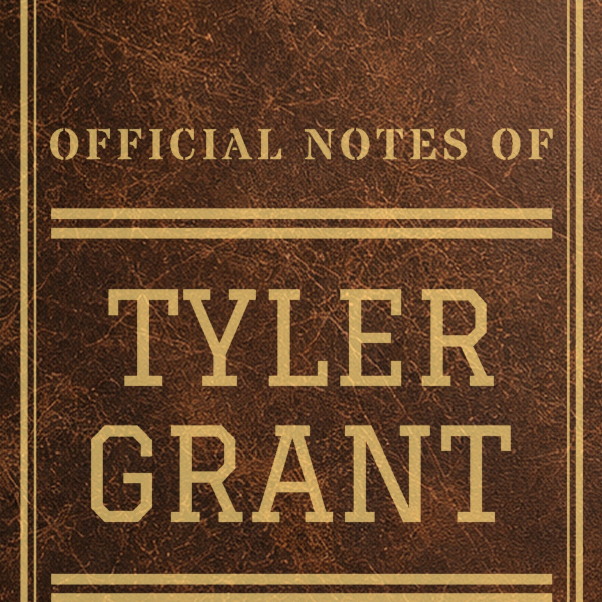 Close-up of the gold laser engraving on the brown college journal: Official Notes Of Tyler Grant in big varsity letters between athletic stripes