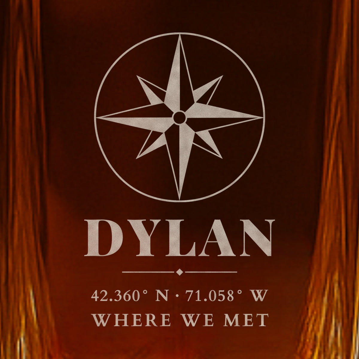 Close-up of the frosted engraving on a whiskey decanter for boyfriend: a compass rose, the name Dylan, Boston coordinates and the words Where We Met