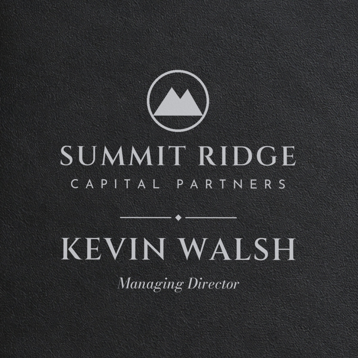 Close-up of the silver laser engraving on the black logo padfolio: a sample Summit Ridge logo, Kevin Walsh and Managing Director in italic