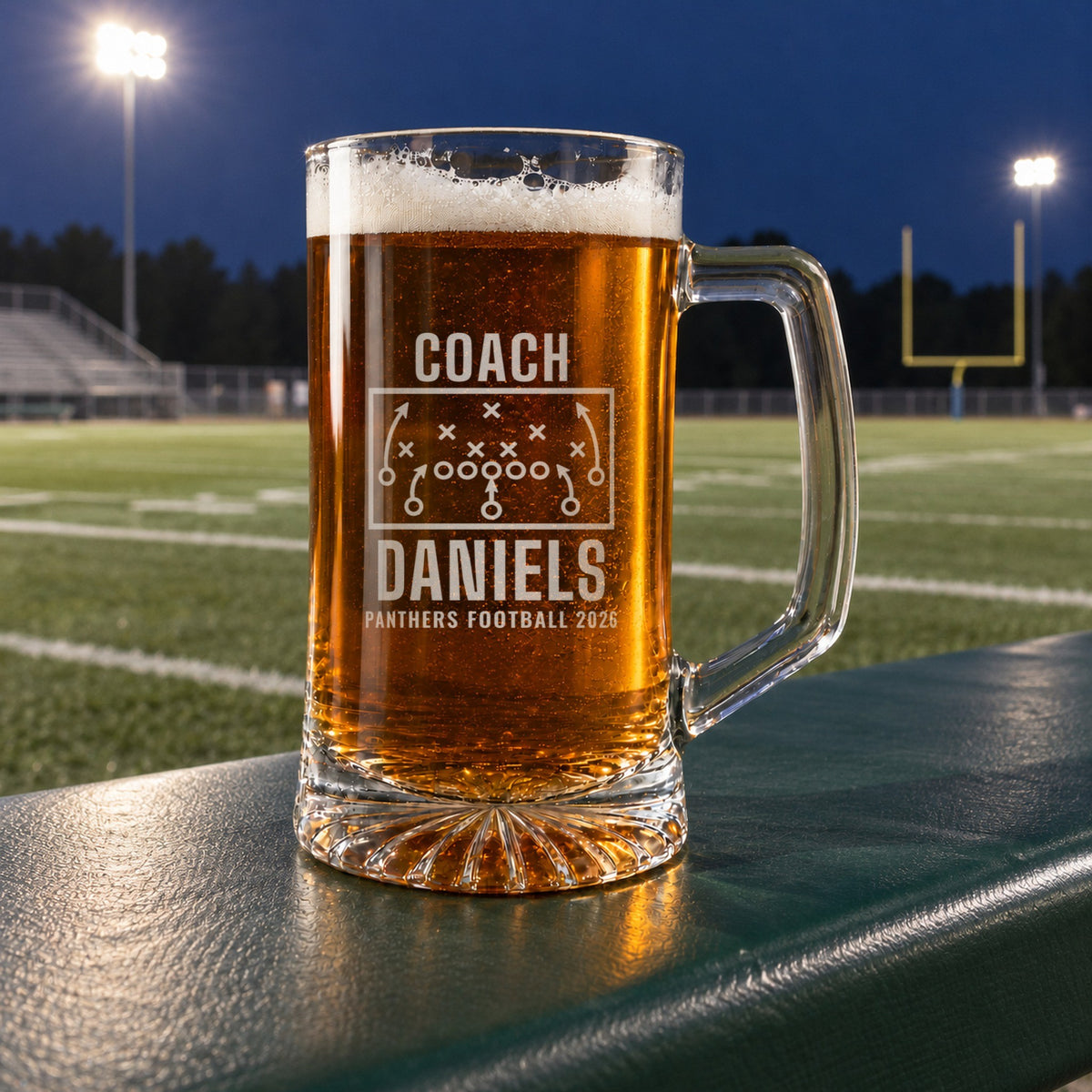 Personalized football coach playbook beer stein in a real setting, engraved with a football play diagram with X's, O's and routes: Coach, Daniels, Panthers Football 2026