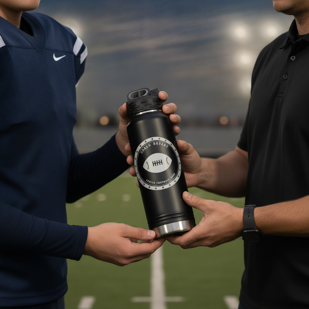 Football player handing his coach a personalized water bottle engraved with a football championship seal at a stadium sideline
