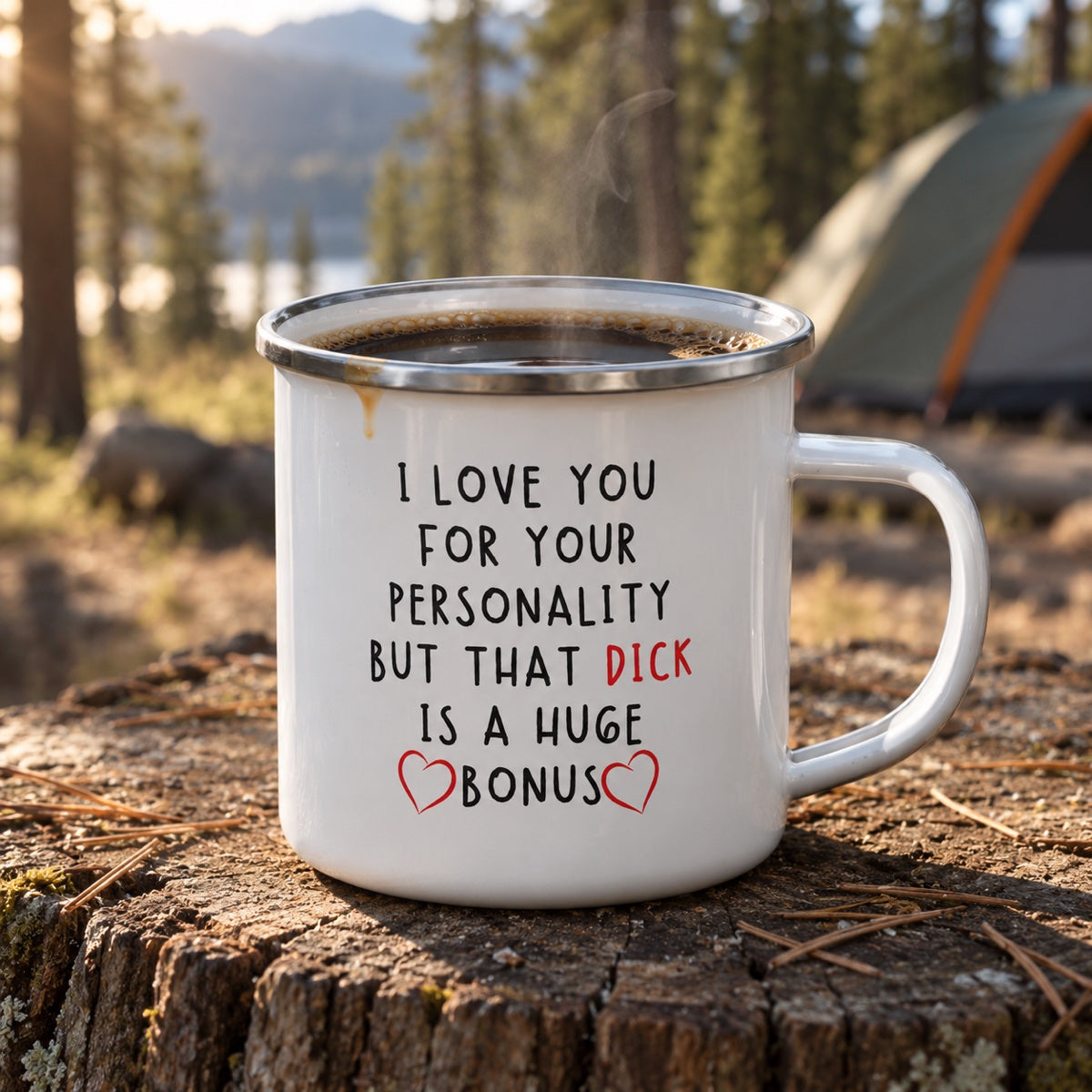 Funny enamel campfire mug for him printed I LOVE YOU FOR YOUR PERSONALITY BUT THAT DICK IS A HUGE BONUS, filled with coffee on a stump at camp
