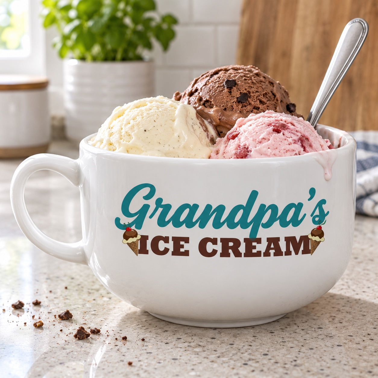 Giant personalized ice cream bowl printed with Grandpa's above ICE CREAM, filled with vanilla, chocolate and strawberry scoops on a kitchen counter