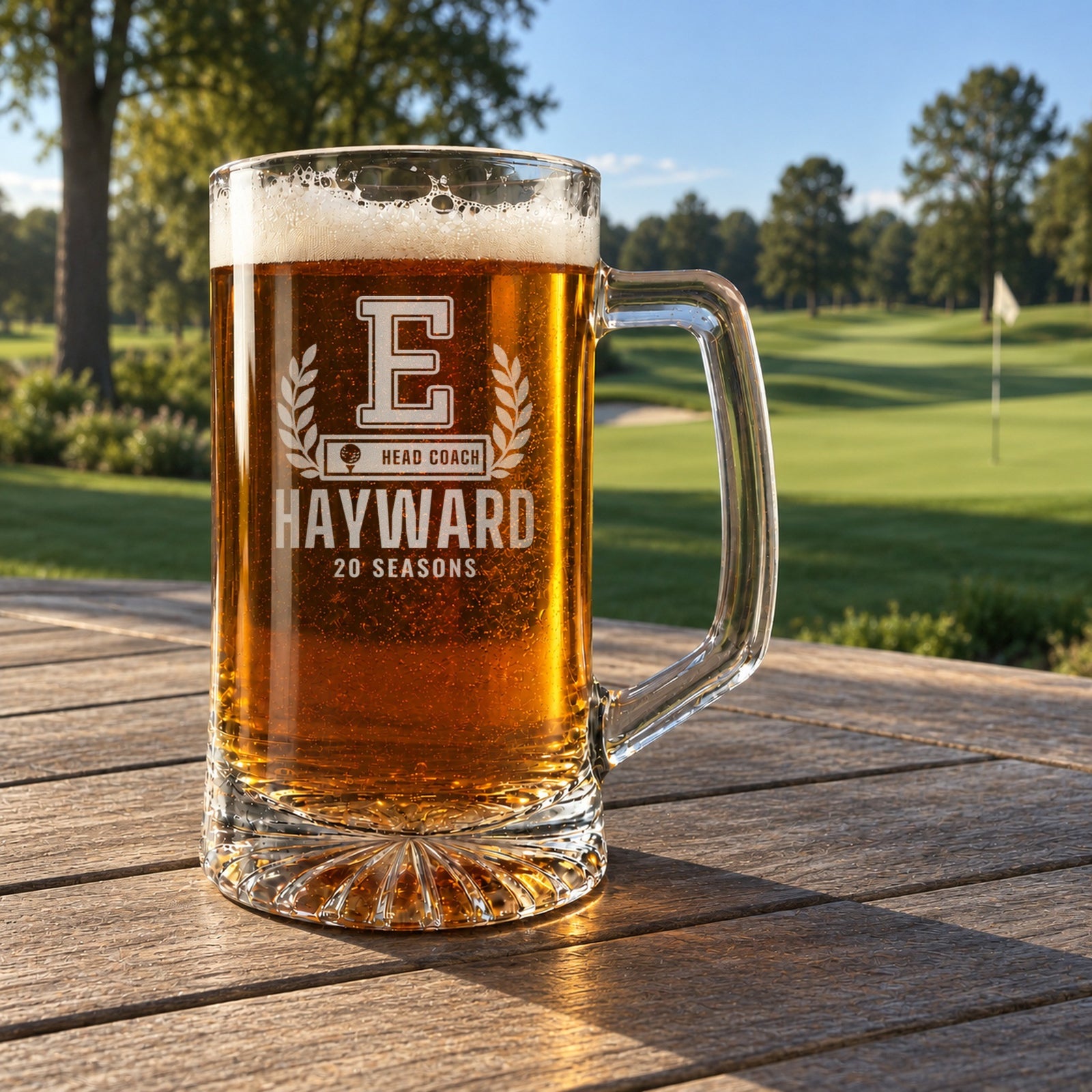 Personalized golf coach letterman beer stein in a real setting, engraved with a varsity letter with laurel and a golf ball COACH bar: E, Head Coach, Hayward, 20 Seasons