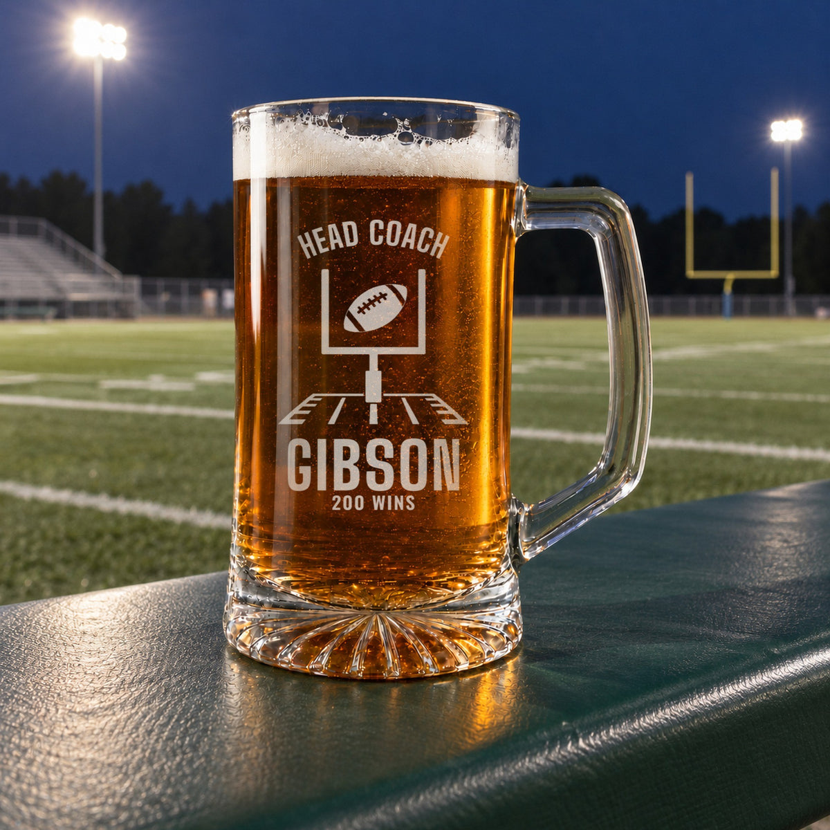Personalized head coach football beer stein in a real setting, engraved with football goalposts with a ball sailing through: Head Coach, Gibson, 200 Wins