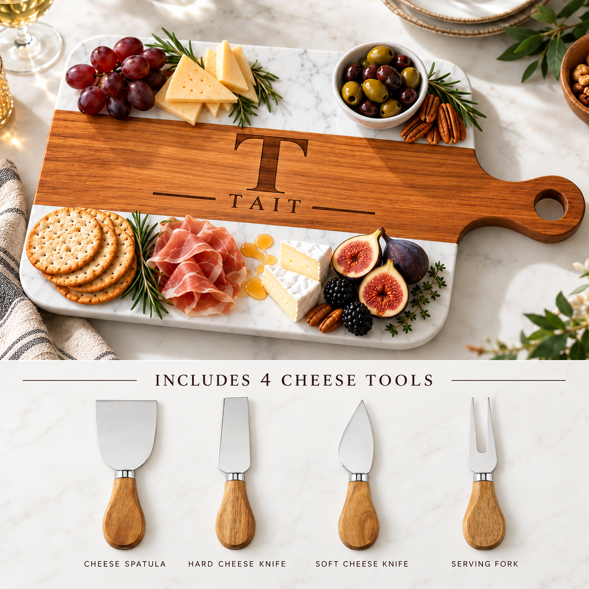 Personalized serving board engraved with T and TAIT beside its four included cheese tools: a cheese spatula, hard cheese knife, soft cheese knife, and serving fork