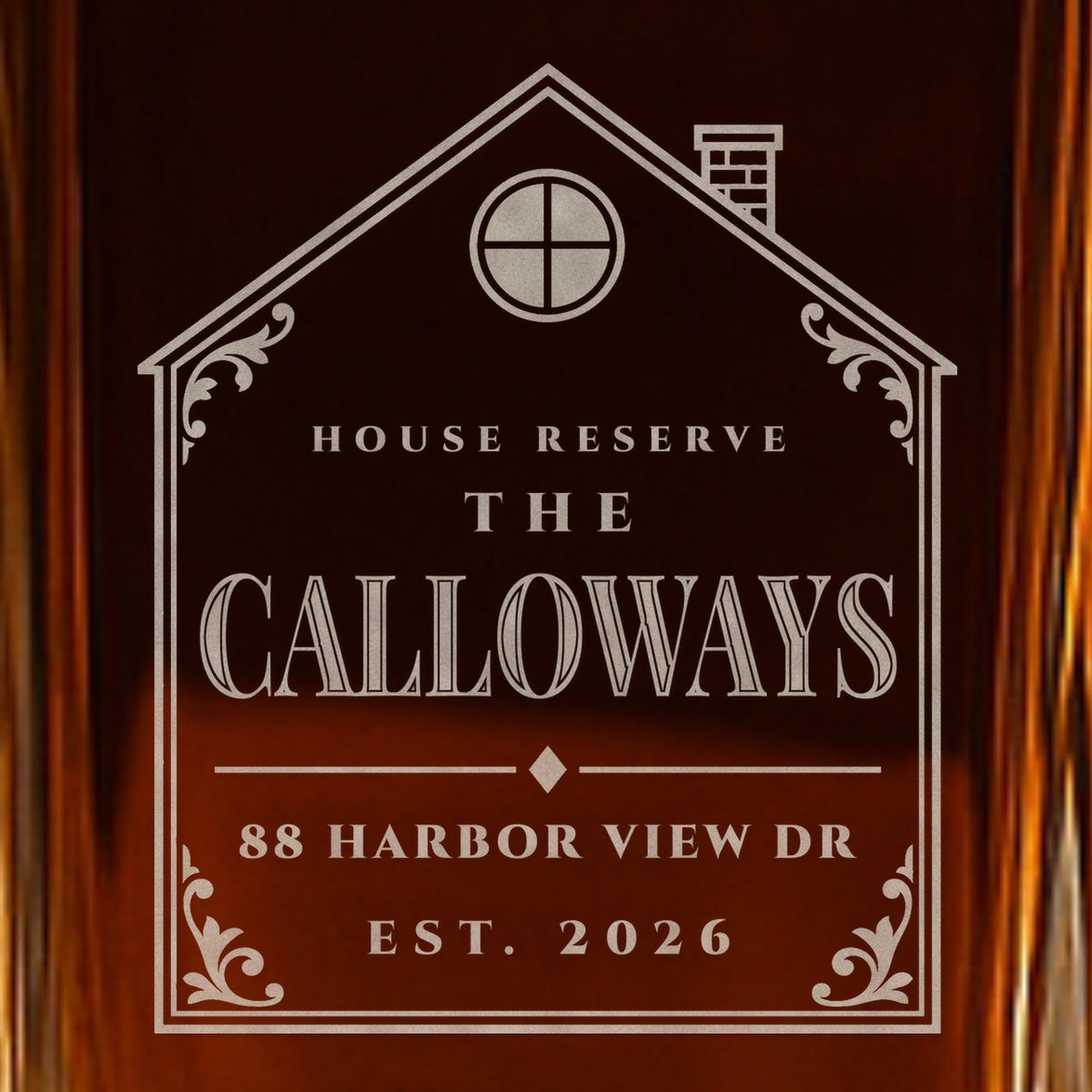 Close-up of the frosted House Reserve label on a closing gift decanter: a house-shaped frame, The Calloways and 88 Harbor View Dr, Est. 2026