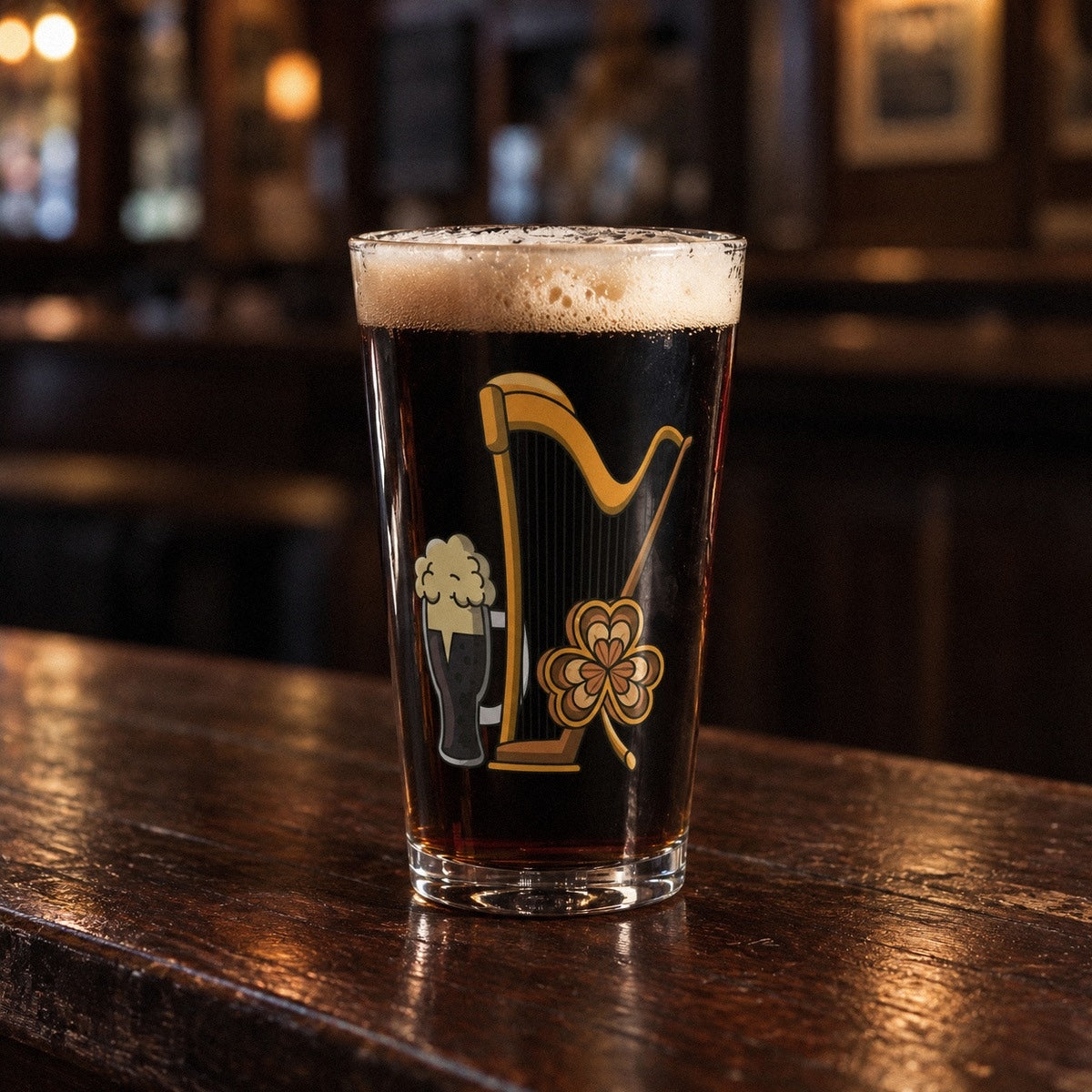 Irish harp pint glass full of dark stout on a pub bar, printed with a golden Celtic harp, a cartoon pint of stout and a knotwork shamrock