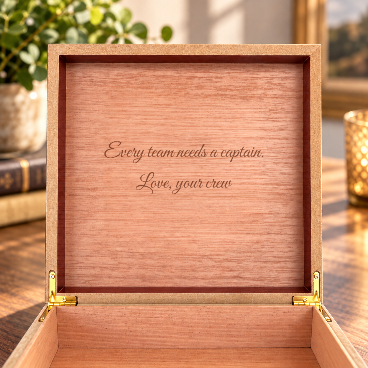 Inside of the keepsake box lid, light Spanish cedar engraved in script with Every team needs a captain. Love, your crew