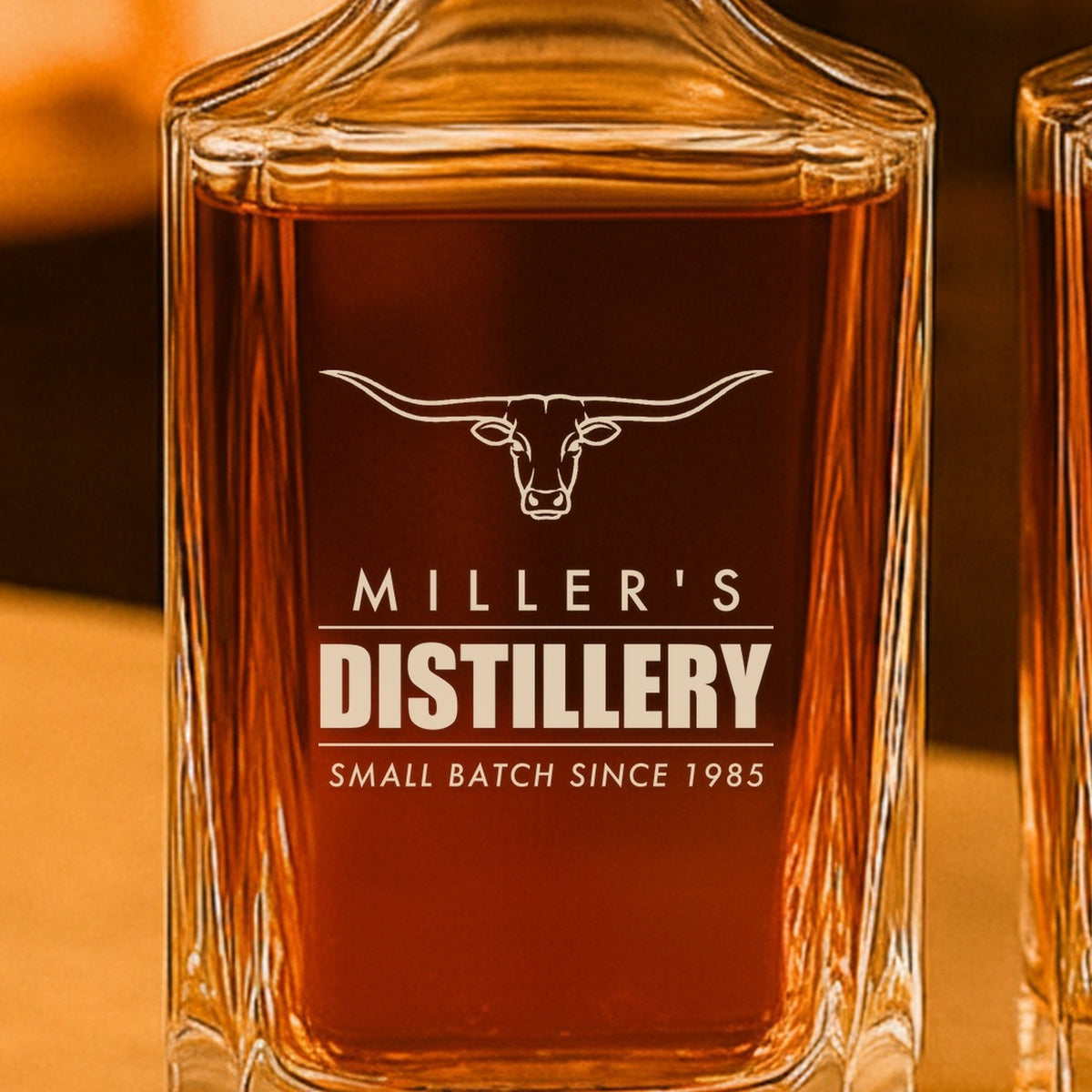 Close-up of the frosted laser engraving on the whiskey decanter: a longhorn steer over Miller's, Distillery and Small Batch Since 1985