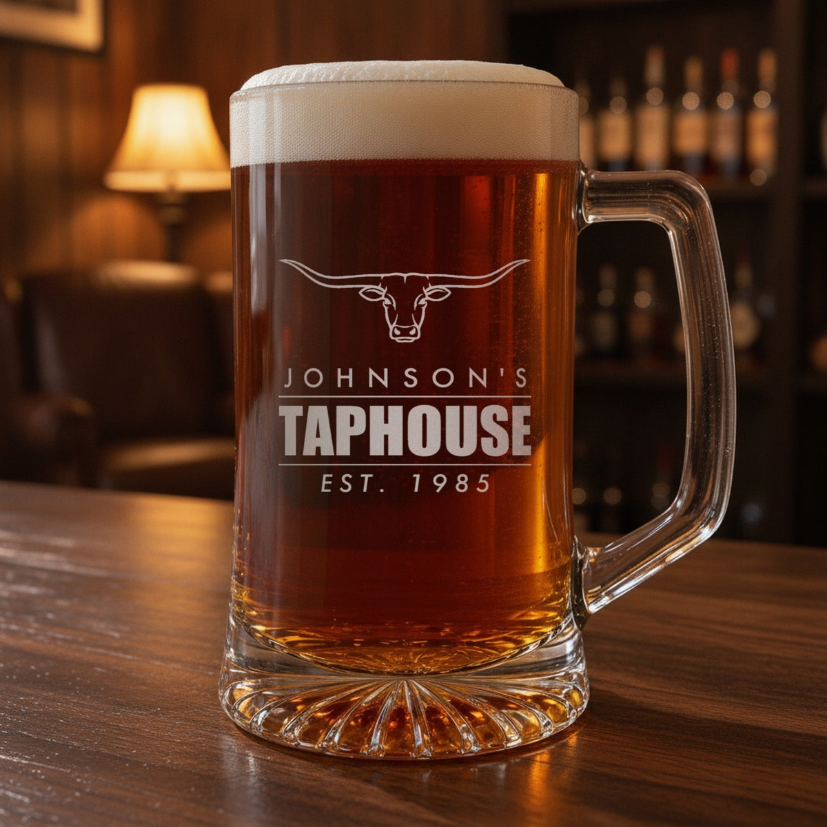 Personalized beer stein on a home bar, engraved with a Texas longhorn over Johnson's Taphouse and Est. 1985 like an old bar sign