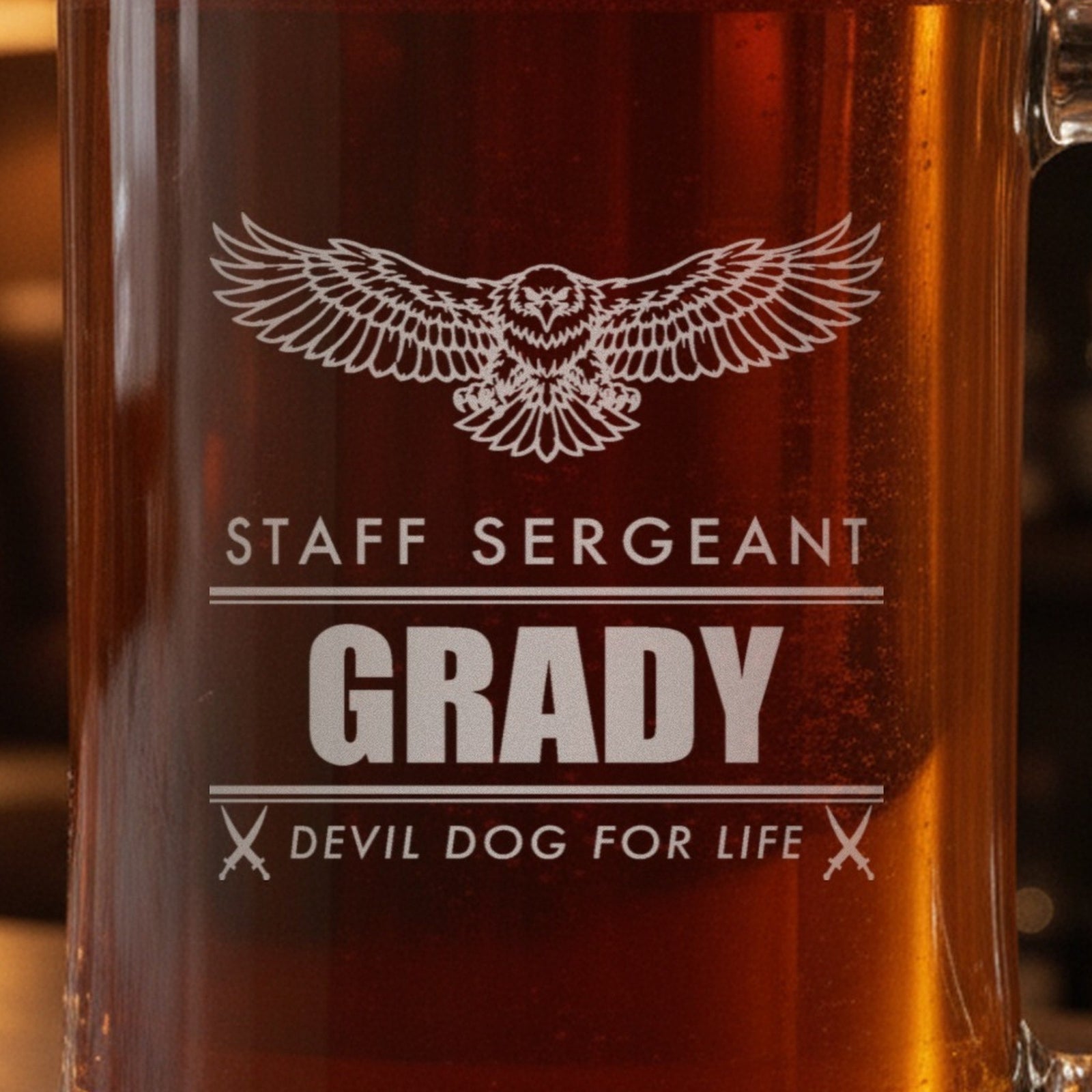 Close-up of the frosted eagle engraving on a retired Marine gift stein: Staff Sergeant, Grady between double rules and Devil Dog for Life