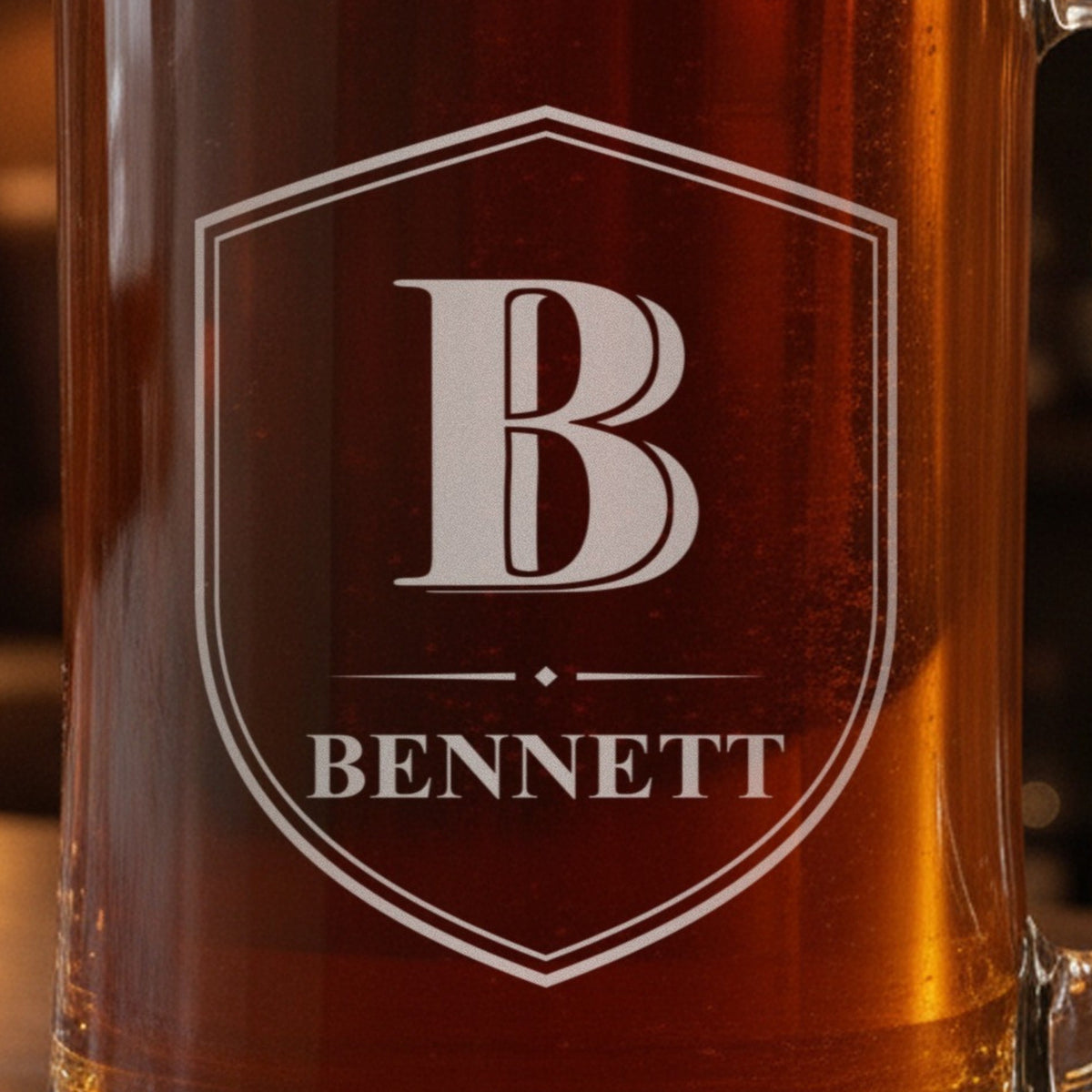 Close-up of the frosted laser engraving on the monogram beer stein, a Shield Crest with the initial B, a diamond divider and the name Bennett