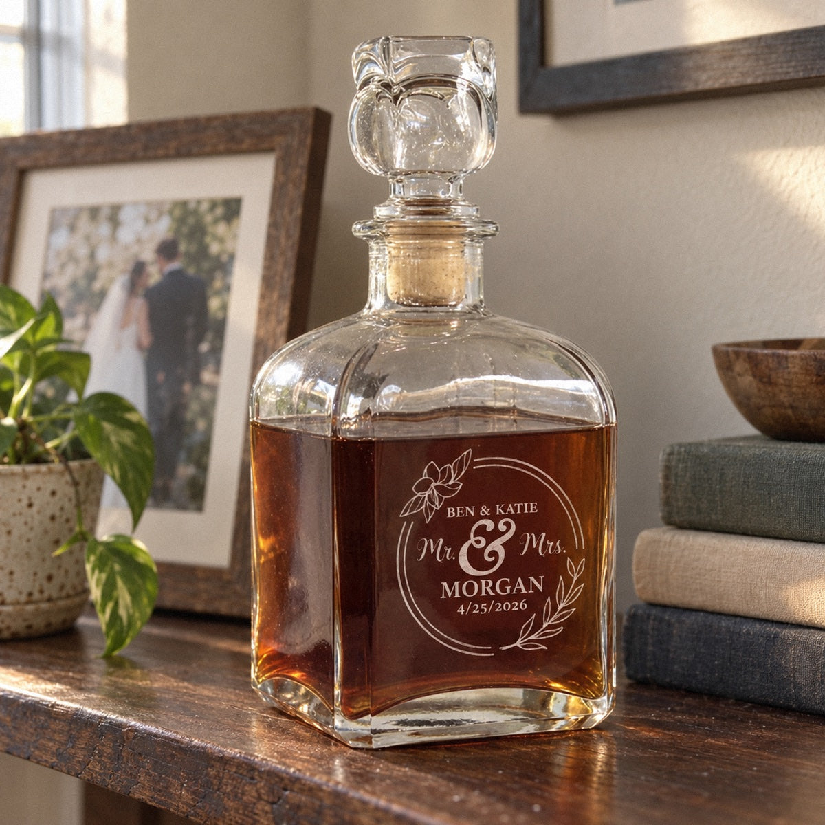 Mr and Mrs decanter etched BEN & KATIE MORGAN on a living room shelf beside their framed wedding photo, a personalized wedding gift