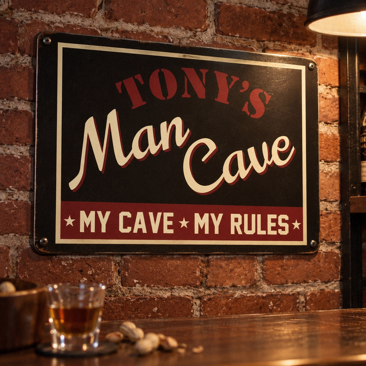 My Cave My Rules man cave sign printed TONY'S over Man Cave in retro script, an 18 by 12 inch metal sign on a brick basement wall