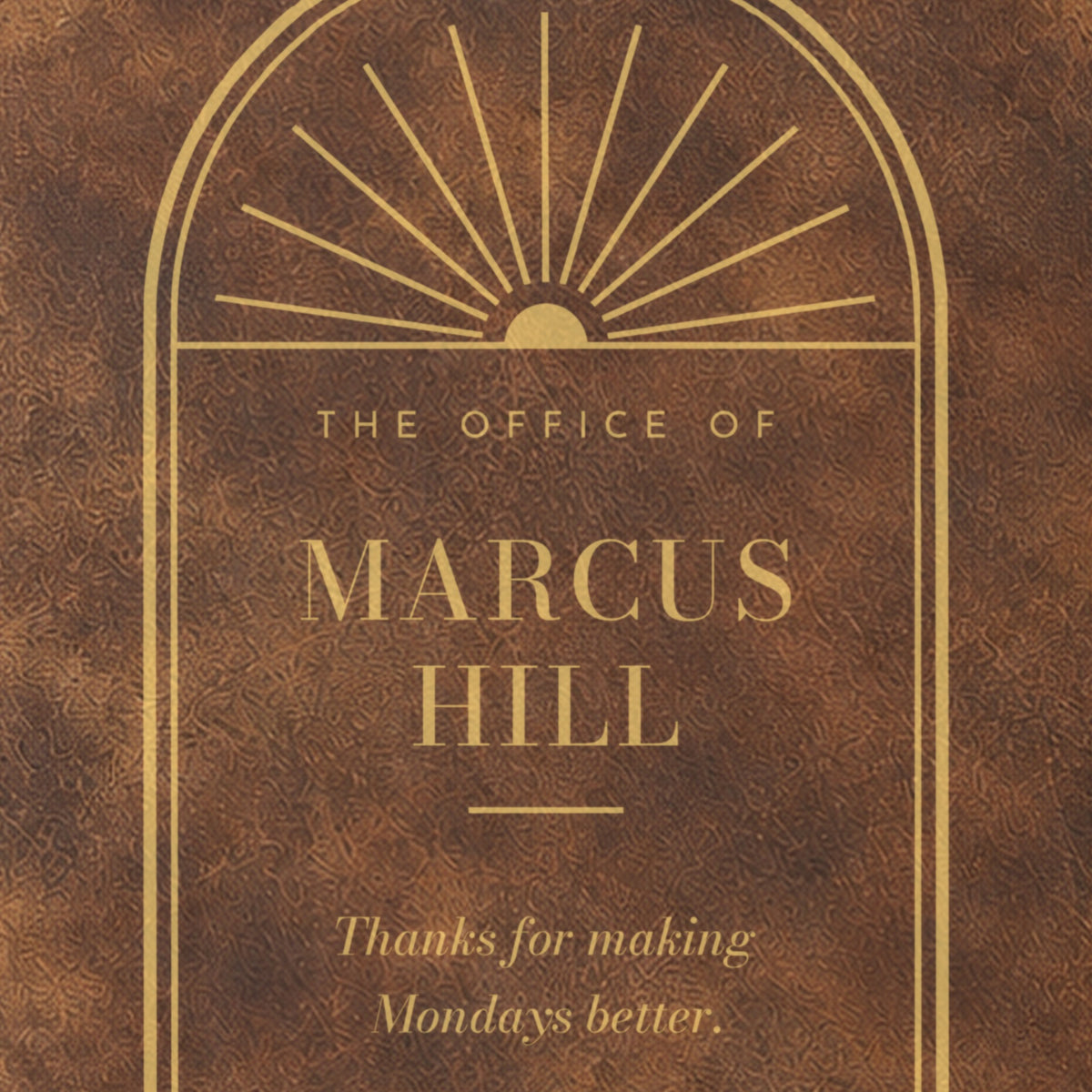 Close-up of the engraving on the Corner Office journal: the arched sunburst window above The Office of Marcus Hill in tall capitals