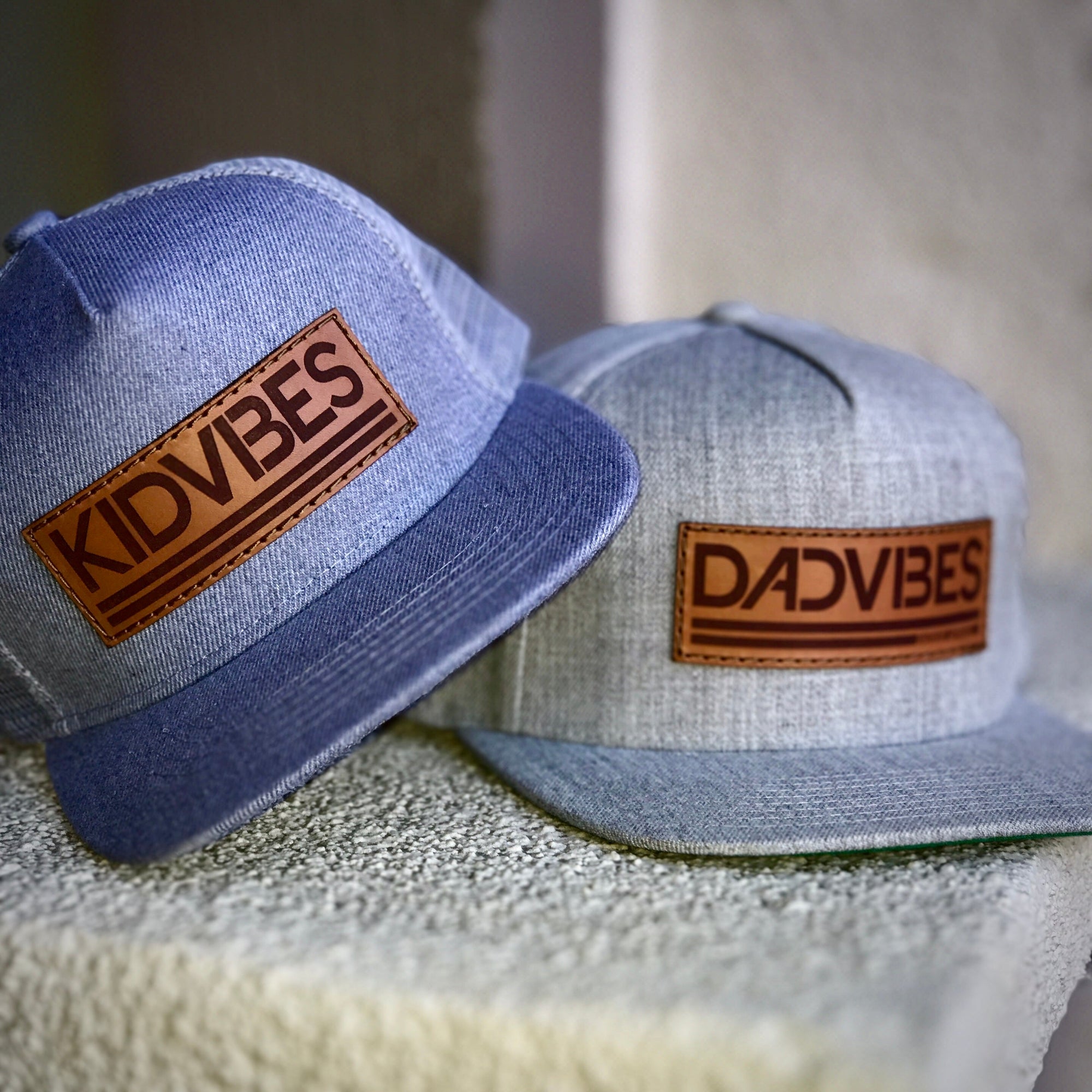 Heather grey Dad Vibes hat with brown leather patch and adjustable snapback.