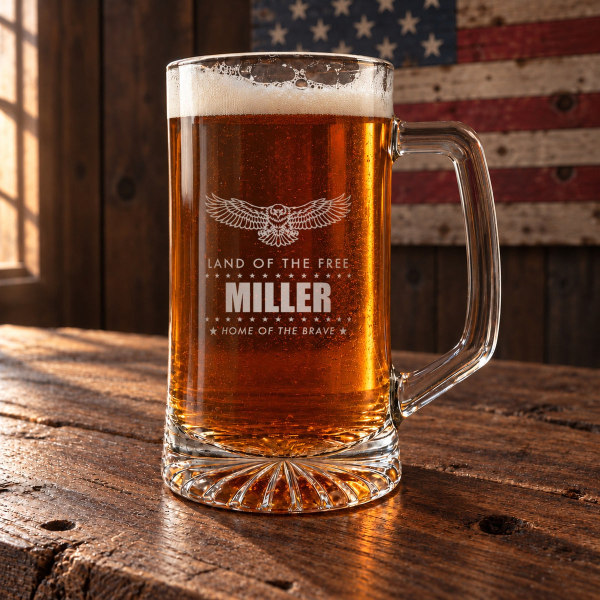 Patriotic personalized beer stein on a barn-wood table with a wooden American flag behind it, engraved with an eagle, Land of the Free and Miller