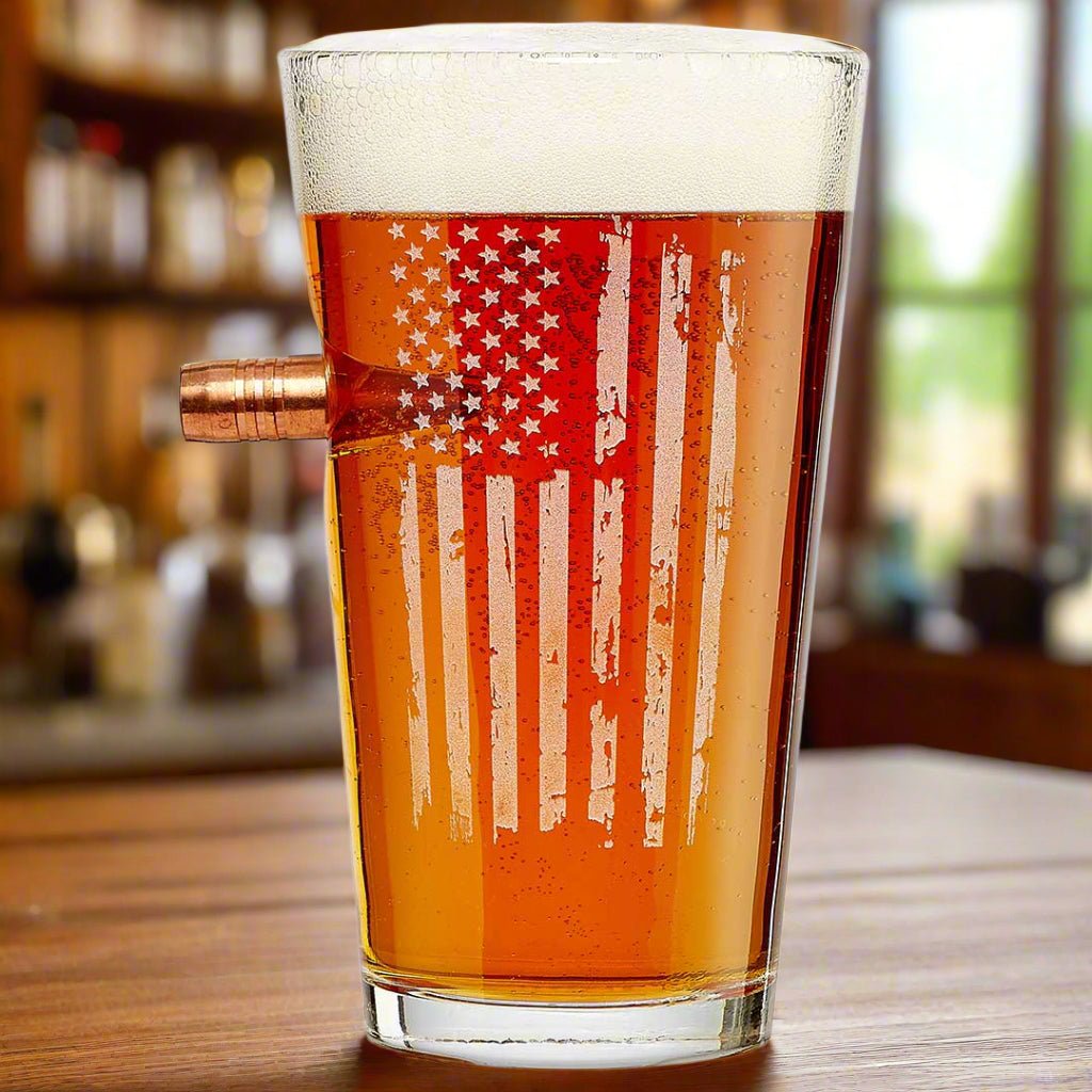  .50 cal bullet pint glass with American flag engraving filled with beer