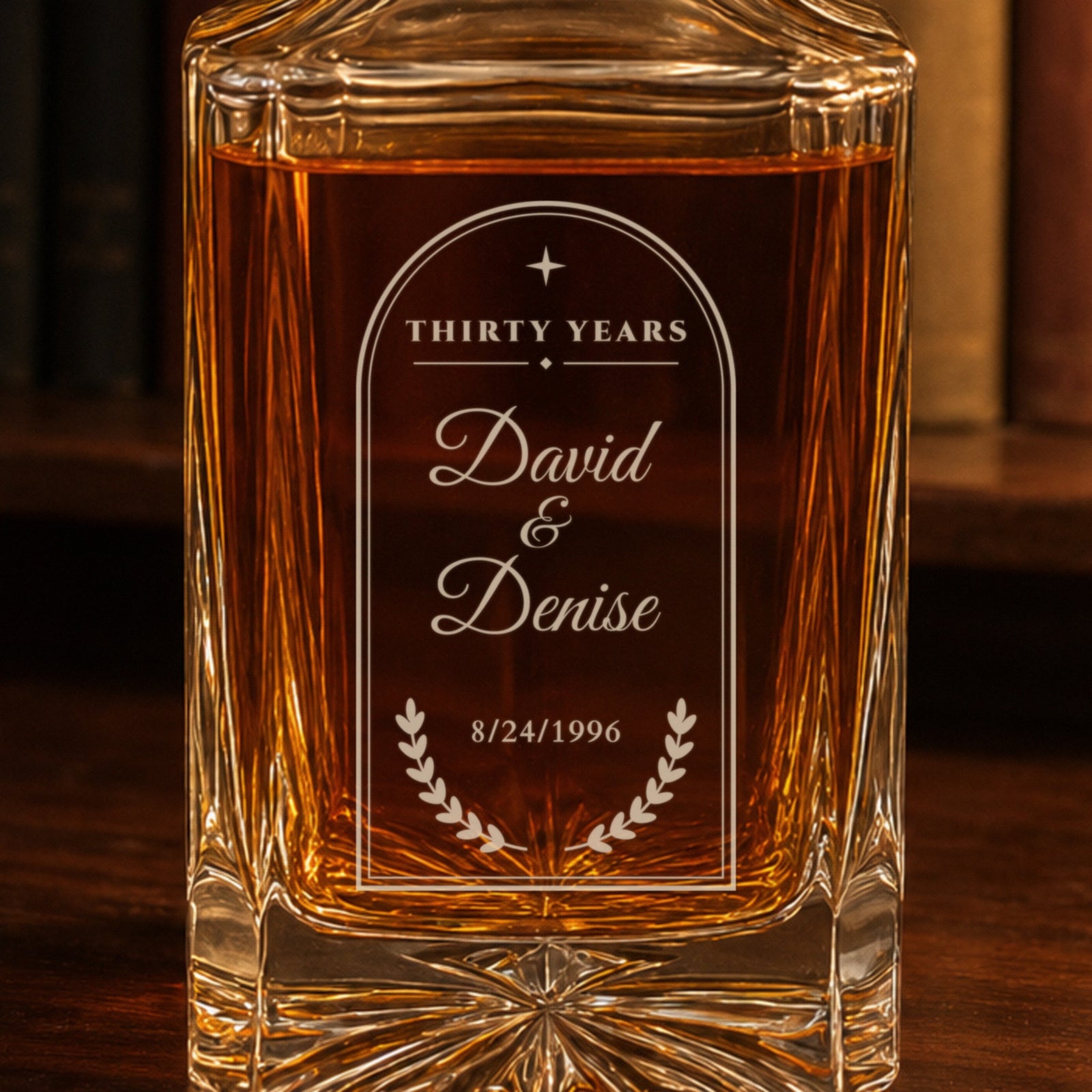 Close-up of the frosted laser engraving on a 30th anniversary decanter for husband: arched frame, Thirty Years, David and Denise, laurel, 8/24/1996