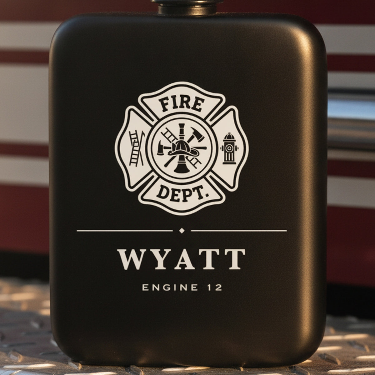 Personalized firefighter flask engraved Engine 12 standing on the diamond plate rear step of a red fire engine in afternoon light.