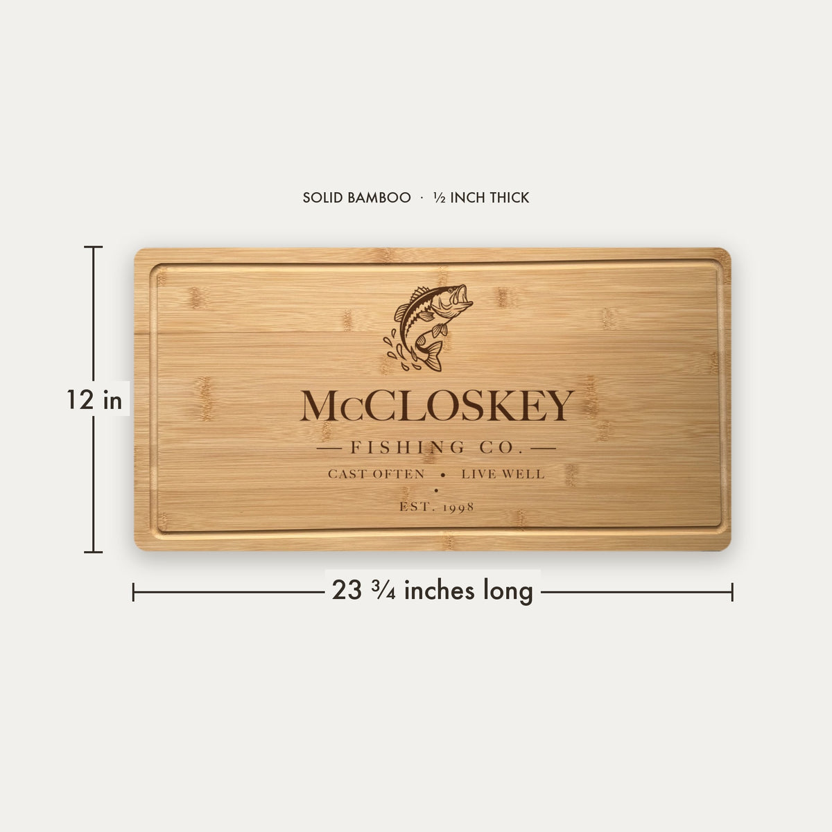 Size guide for the personalized fishing cutting board, 23 and three quarter inches long by 12 inches wide in half inch thick solid bamboo.