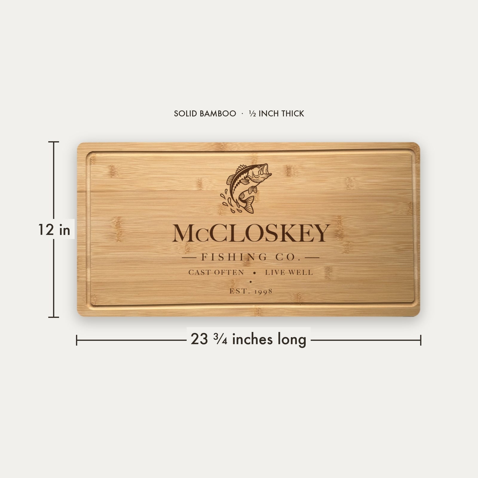 Size guide for the personalized fishing cutting board, 23 and three quarter inches long by 12 inches wide in half inch thick solid bamboo.