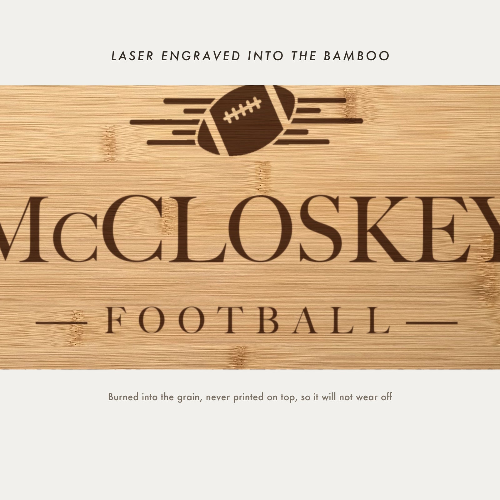 Close view of the football with speed lines laser engraved into the bamboo grain above the family name in a high contrast serif.
