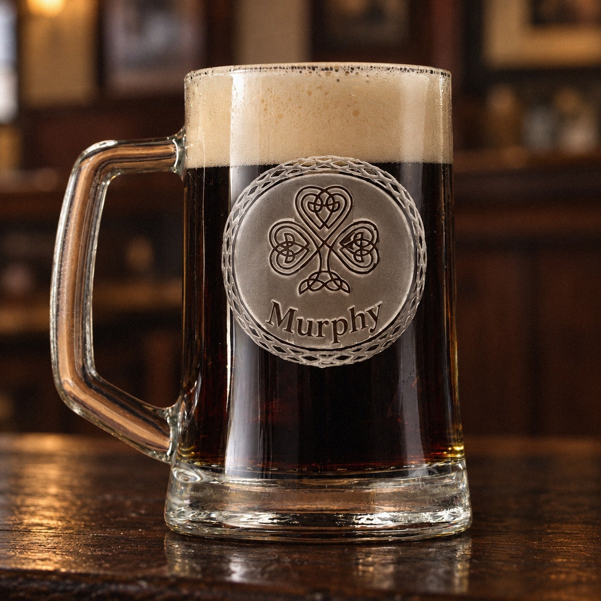 Personalized Irish beer mug full of stout on a pub bar, sand-carved with a Celtic knotwork shamrock medallion and the name Murphy