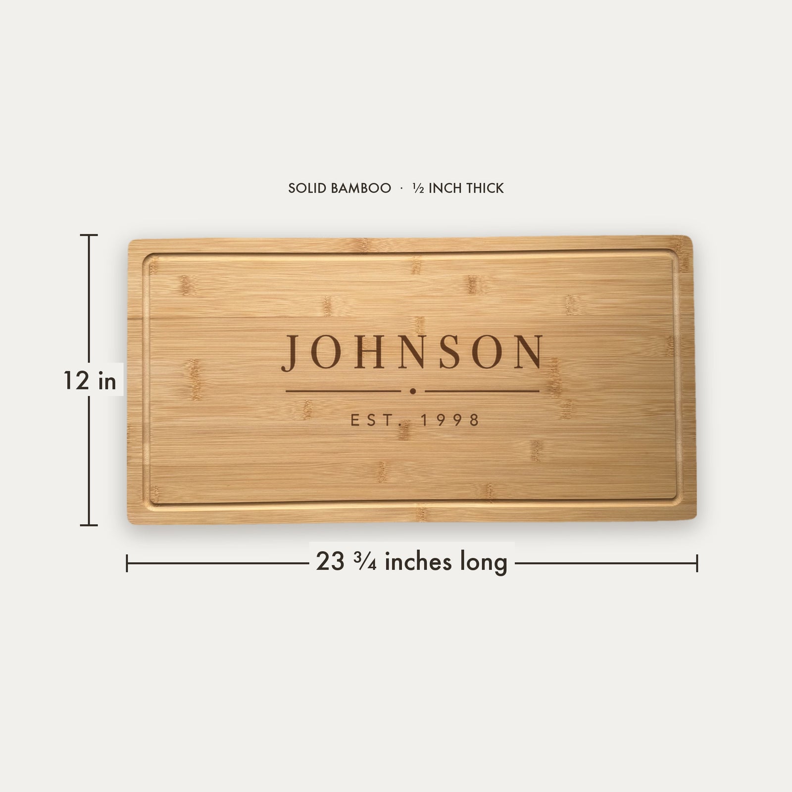 Size guide for the personalized last name cutting board, 23 and three quarter inches long by 12 inches wide in half inch thick solid bamboo.