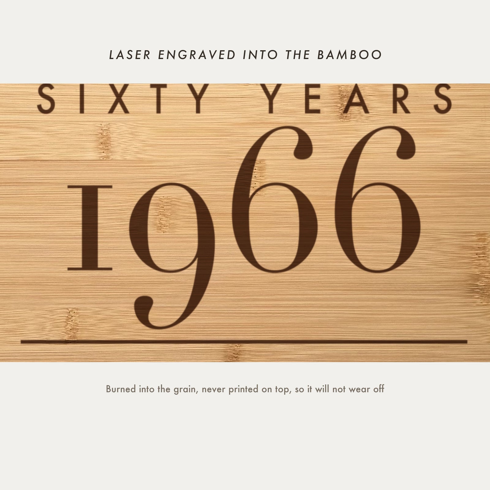 Close view of Sixty Years and the birth year 1966 laser engraved into the bamboo grain in a tall elegant serif above the family name.
