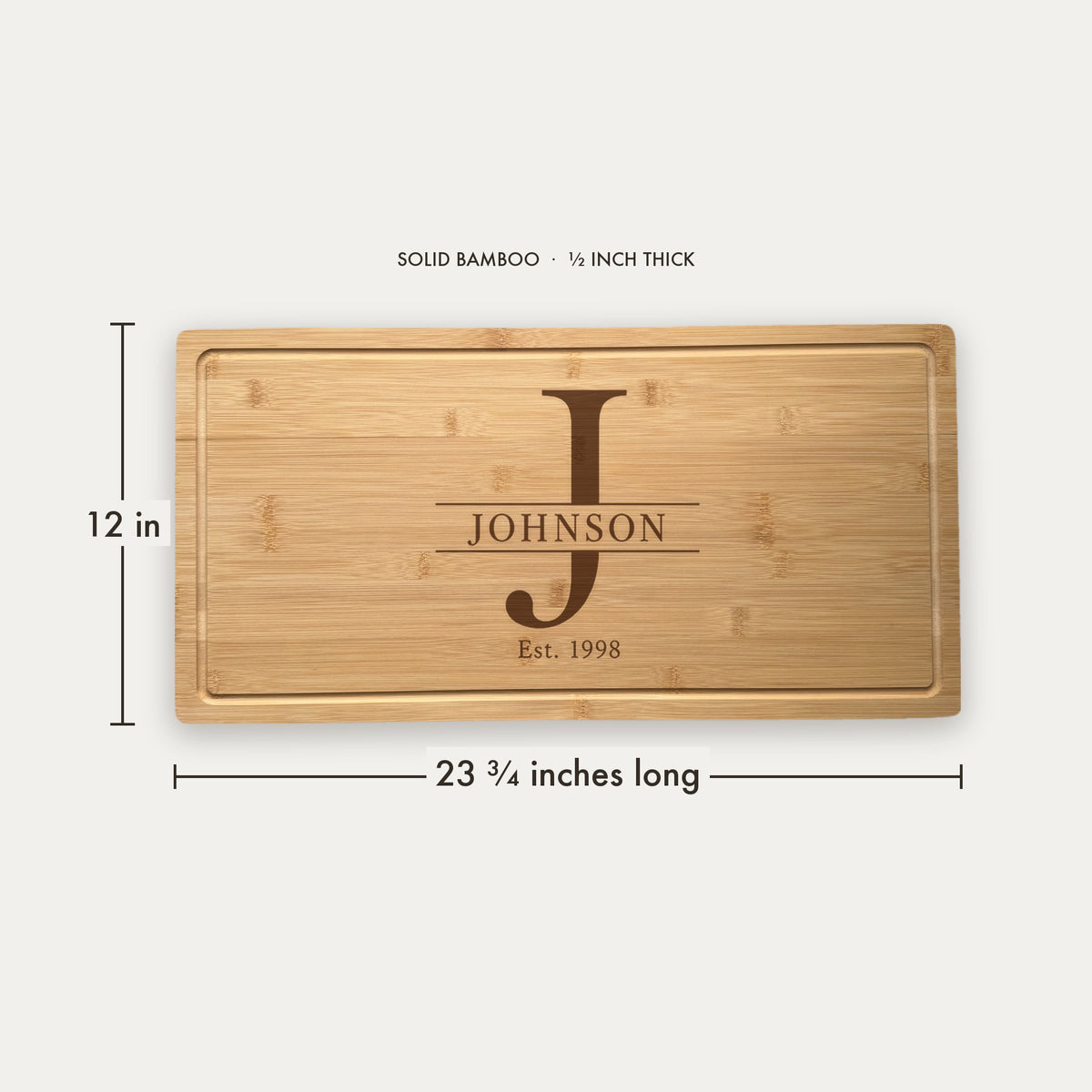 Size guide for the personalized monogram cutting board, 23 and three quarter inches long by 12 inches wide in half inch thick solid bamboo.