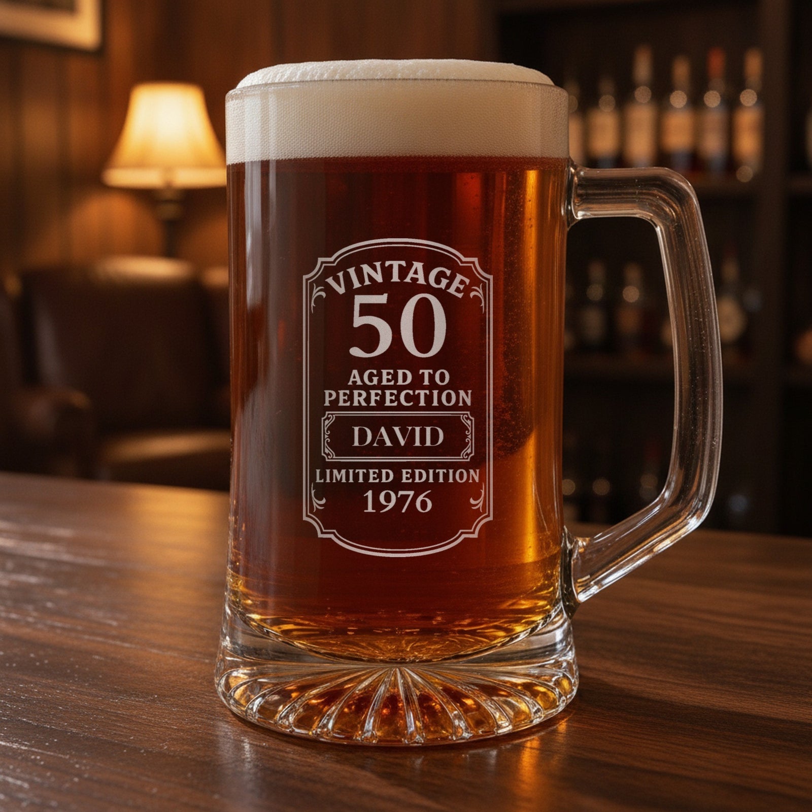 Personalized vintage birthday beer stein on a walnut home bar, engraved Vintage 50 Aged to Perfection label with the name David and 1976