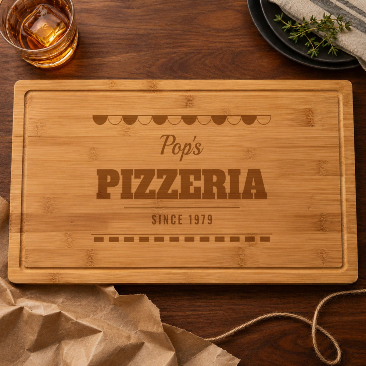 Personalized pizzeria cutting board engraved Pop's PIZZERIA SINCE 1979, just unwrapped from brown kraft paper, a gift for the pizza maker