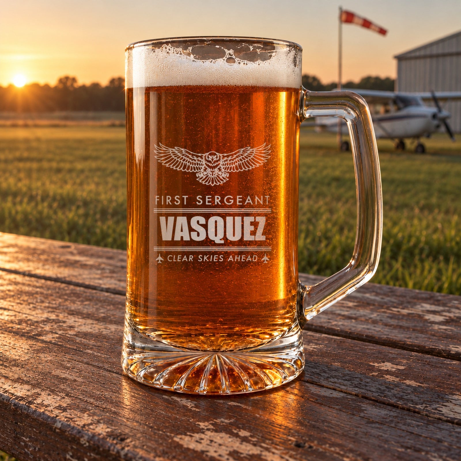 Engraved Air Force retirement beer stein on a picnic table at a small airfield at sunset, personalized First Sergeant, Vasquez, Clear Skies Ahead