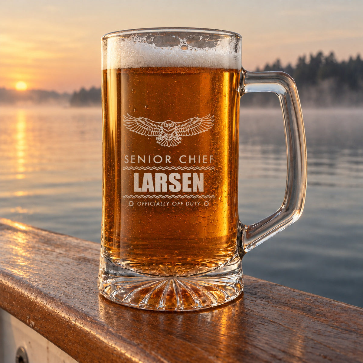 Engraved Coast Guard retirement beer stein on a boat rail over calm water at dawn, personalized Senior Chief, Larsen and Officially Off Duty